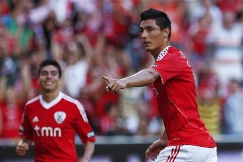 Benfica's Oscar Cardozo, right, from Paraguay, celebrates with teammate Nico Gaitan, from Argentina, after scoring the opening goal during their Portuguese League soccer match with Guimaraes Saturday, Sept. 10, 2011 at Benfica's Luz stadium in Lisbon. (AP Photo/ Francisco Seco)