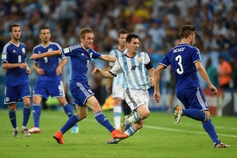 RIO DE JANEIRO, BRAZIL - JUNE 15: Lionel Messi of Argentina is fouled by Edin Visca of Bosnia and Herzegovina during the 2014 FIFA World Cup Brazil Group F match between Argentina and Bosnia-Herzegovina at Maracana on June 15, 2014 in Rio de Janeiro, Brazil.  (Photo by Matthias Hangst/Getty Images)