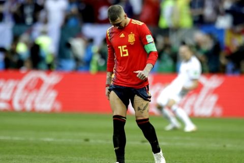 Spain's Sergio Ramos walks over the pitch during the penalty shootout before his team was eliminated during the round of 16 match between Spain and Russia at the 2018 soccer World Cup at the Luzhniki Stadium in Moscow, Russia, Sunday, July 1, 2018. (AP Photo/Matthias Schrader)