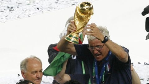 Italy's coach Marcello Lippi holds the trophy at the end of the soccer World Cup between Italy and France in the Olympic Stadium in Berlin, Sunday, July 9, 2006.  (AP Photo/Andrew Medichini)  ** MOBILE/PDA USAGE OUT **