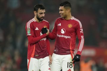 Manchester United's Casemiro, right, reacts with his teammate Bruno Fernandes after winning the English League Cup soccer match between Manchester United and Leicester City at the Old Trafford stadium in Manchester, England, Wednesday, Oct. 30, 2024. (AP Photo/Dave Thompson)