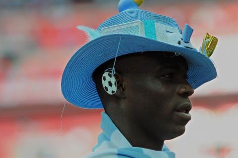 Manchester City's Italian footballer Mario Balotelli wears a hat following his team's victory over Stoke during the FA Cup final football match between Manchester City and Stoke City at Wembley Stadium in London, on May 14, 2011. AFP PHOTO / ANDREW YATES
NOT FOR MARKETING OR ADVERTISING USE/RESTRICTED TO EDITORIAL USE (Photo credit should read ANDREW YATES/AFP/Getty Images)