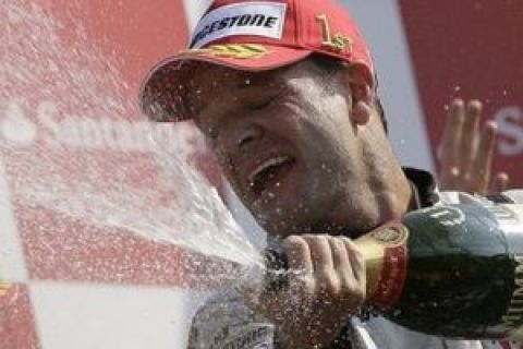 Brawn GP driver Rubens Barrichello of Brazil celebrates on the podium after winning the Italian Formula One Grand Prix race, in Monza, Italy, Sunday, Sept. 13,  2009.  (AP Photo/Alberto Pellaschiar)