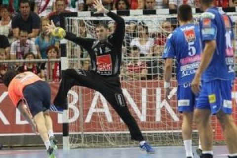 A shot by Juanin Garcia, left, of Barcelona of Spain is saved by goalie Nandor Fazekas, center, of MKB Veszprem of Hungary during their men's handball Champions' League quarterfinal second leg match in Veszprem, 108 kms southwest of Budapest, Hungary, Saturday, May 1, 2010. (AP Photo/MTI, Aniko Kovacs)