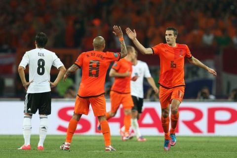 KHARKOV, UKRAINE - JUNE 13:  Robin van Persie of Netherlands celebrates scoring their first goal with Nigel de Jong of Netherlands during the UEFA EURO 2012 group B match between Netherlands and Germany at Metalist Stadium on June 13, 2012 in Kharkov, Ukraine.  (Photo by Joern Pollex/Getty Images)