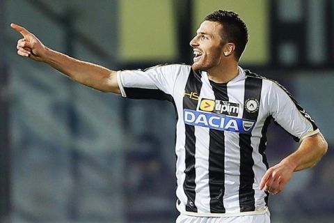 Udinese's Thomas Heurtaux, of France, celebrates after scoring his side's second goal during a Serie A soccer match between Livorno and Udinese, in Leghorn, Italy, Saturday, Dec. 21, 2013. (AP Photo/Francesco Speranza )