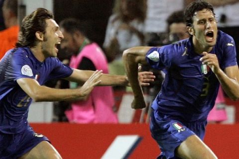 **RETRANSMISSION FOR ALTERNATE CROP**  Italy's Fabio Grosso, right, celebrates with teammate Andrea Pirlo after scoring the first goal in the extra time of the semifinal World Cup soccer match between Germany and Italy in Dortmund, Germany, Tuesday, July 4, 2006. Italy won the match 2-0 in extra time. (AP Photo/Jasper Juinen)  ** MOBILE/PDA USAGE OUT **