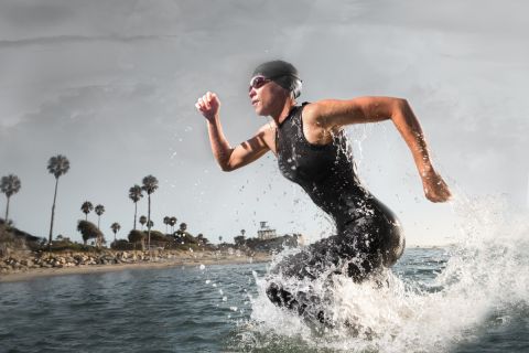 Triathlon Athlete rushing out of the water.