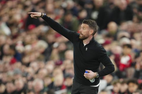 Luton Town's head coach Rob Edwards gestures during the English Premier League soccer match between Liverpool and Luton Town, at Anfield stadium in Liverpool, England, Wednesday, Feb. 21, 2024. (AP Photo/Jon Super)