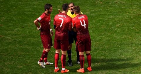 BRASILIA, BRAZIL - JUNE 26:  Joao Moutinho, Cristiano Ronaldo and Miguel Veloso of Portugal protest to referee Nawaf Shukralla during the 2014 FIFA World Cup Brazil Group G match between Portugal and Ghana at Estadio Nacional on June 26, 2014 in Brasilia, Brazil.  (Photo by Christopher Lee/Getty Images)