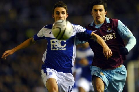 Birmingham City's Matt Derbyshire (L) and West Ham United's James Tomkins conmpete for the ball during their English League Cup semi final second leg football match at St Andrew's in Birmingham, on January 26, 2011. AFP PHOTO/PAUL ELLIS --- RESTRICTED TO EDITORIAL USE Additional licence required for any commercial/promotional use or use on TV or internet (except identical online version of newspaper) of Premier League/Football League photos. Tel DataCo +44 207 2981656. Do not alter/modify photo (Photo credit should read PAUL ELLIS/AFP/Getty Images)