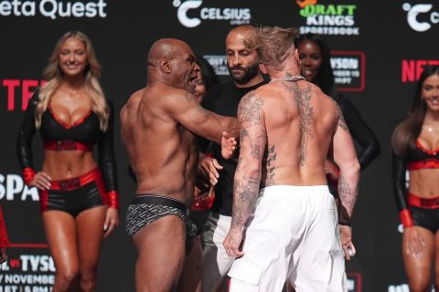 Mike Tyson, left, slaps Jake Paul during a weigh-in ahead of their heavyweight bout, Thursday, Nov. 14, 2024, in Irving, Texas. (AP Photo/Julio Cortez)