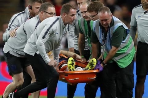 England's Luke Shaw is carried off the pitch on a stretcher after he injured himself during the UEFA Nations League soccer match between England and Spain at Wembley stadium in London, Saturday Sept. 8, 2018. (AP Photo/Frank Augstein)