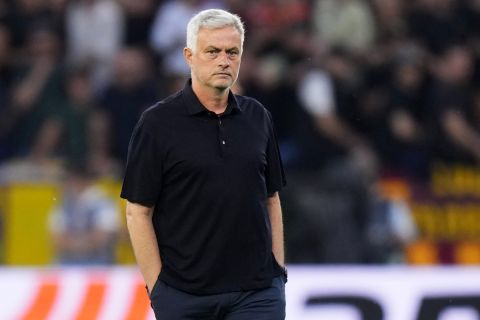 Roma's head coach Jose Mourinho walks on the pitch during warmup before the Europa League final soccer match between Sevilla and Roma, at the Puskas Arena in Budapest, Hungary, Wednesday, May 31, 2023. (AP Photo/Petr David Josek)