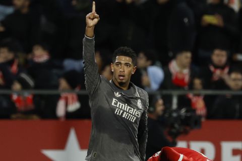 Real Madrid's Jude Bellingham celebrates after scoring the opening goal during a Spanish La Liga soccer match between Girona and Real Madrid at the Montilivi stadium in Girona, Spain, Saturday, Dec. 7, 2024. (AP Photo/Joan Monfort)