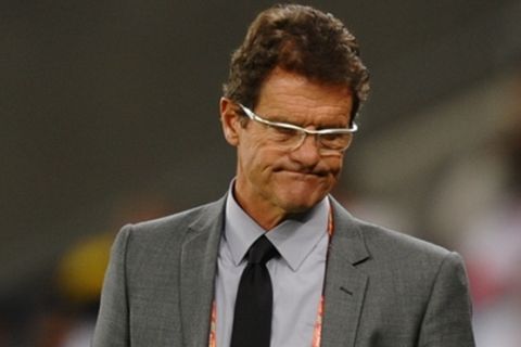 England's coach Fabio Capello looks dejected at the end of the Group C first round 2010 World Cup football match England vs. Algeria on June 18, 2010 at Green Point stadium in Cape Town. The match ended in a 0-0 draw.  NO PUSH TO MOBILE / MOBILE USE SOLELY WITHIN EDITORIAL ARTICLE   -        AFP PHOTO / PAUL ELLIS (Photo credit should read PAUL ELLIS/AFP/Getty Images)