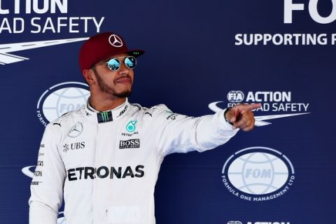 MONTMELO, SPAIN - MAY 14:  Lewis Hamilton of Great Britain and Mercedes GP celebrates after getting pole position in parc ferme during qualifying for the Spanish Formula One Grand Prix at Circuit de Catalunya on May 14, 2016 in Montmelo, Spain.  (Photo by Mark Thompson/Getty Images)