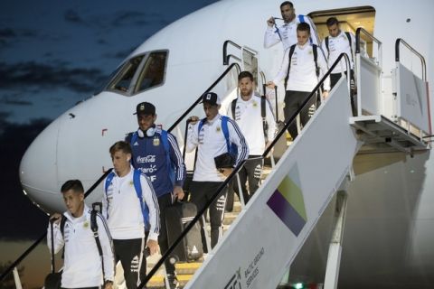 Lionel Messi, center right, Angel Di Maria, center left, and their teammates disembark the plane as the Argentina national soccer team arrive at Zhukovsky international airport outside Moscow, Russia, Saturday, June 9, 2018 to compete in the 2018 World Cup in Russia. The 21st World Cup begins on Thursday, June 14, 2018, when host Russia takes on Saudi Arabia. (AP Photo/Pavel Golovkin)