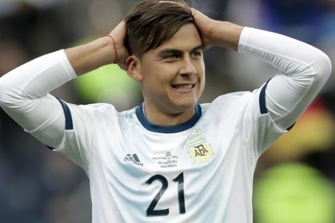 Argentina's Paulo Dybala holds his head after missing a chance to score against Chile during the Copa America third-place soccer match at the Arena Corinthians in Sao Paulo, Brazil, Saturday, July 6, 2019. (AP Photo/Andre Penner)