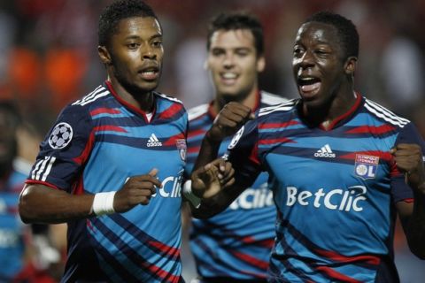 Olympique Lyonnais Michel Bastos (L) celebrates his goal against Hapoel Tel Aviv during their Champions League Group B soccer match at Bloomfield stadium in Tel Aviv September 29, 2010. REUTERS/Ronen Zvulun (ISRAEL - Tags: SPORT SOCCER)