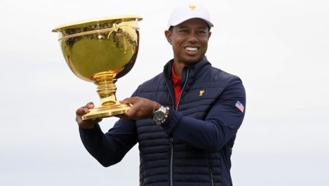 U.S. team player and captain Tiger Woods holds up the trophy after the U.S. team won the President's Cup golf tournament at Royal Melbourne Golf Club in Melbourne, Sunday, Dec. 15, 2019. The U.S. team won the tournament 16-14. (AP Photo/Andy Brownbill)