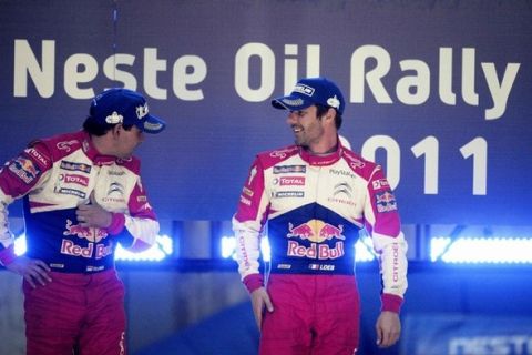 French driver Sebastien Loeb (R) and his co-driver Daniel Elena celebrate their victory of the FIA World Rally Championship WRC Neste Oil Rally on the podium in Jyvaskyla, Finland July 30, 2011. REUTERS/Martti Kainulainen/Lehtikuva (FINLAND - Tags: SPORT MOTOR RACING) FINLAND OUT. NO COMMERCIAL OR EDITORIAL SALES IN FINLAND. THIS IMAGE HAS BEEN SUPPLIED BY A THIRD PARTY. IT IS DISTRIBUTED, EXACTLY AS RECEIVED BY REUTERS, AS A SERVICE TO CLIENTS. NO THIRD PARTY SALES. NOT FOR USE BY REUTERS THIRD PARTY DISTRIBUTORS