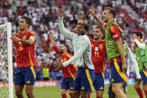 Spain's Rodri, left, and Lamine Yamal, center, celebrates with teammates after a quarterfinal match between Germany and Spain at the Euro 2024 soccer tournament in Stuttgart, Germany, Friday, July 5, 2024. (AP Photo/Antonio Calanni)