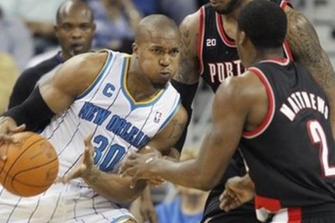 New Orleans Hornets power forward David West (30) moves to the lane as he looks at Portland Trail Blazers guard Wesley Matthews (2) in the second half of an NBA basketball game in New Orleans, Saturday, Nov. 13, 2010. The Hornets defeated the Trail Blazers 107-87 to remain undefeated. (AP Photo/Bill Haber)