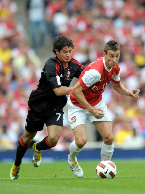 Arsenal's Laurent Koscielny (R) competes with AC Milan's Pato during their Emirates Cup football match at Emirates Stadium in London, England on July 31, 2010.  AFP PHOTO/Olly Greenwood

FOR EDITORIAL USE ONLY Additional license required for any commercial/ promotional use or use on TV or internet (except identical online version of newspaper) of Premier League/Football photos. Tel DataCo  
+44 207 2981656. Do not alter/modify photo. (Photo credit should read OLLY GREENWOOD/AFP/Getty Images)(Photo Credit should Read /AFP/Getty Images)