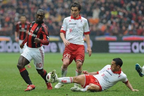 MILAN, ITALY - MARCH 13:  Clarence Seedorf of AC Milan takes on Codrea (R) of AS Bari during the Serie A match between AC Milan and AS Bari at Stadio Giuseppe Meazza on March 13, 2011 in Milan, Italy.  (Photo by Valerio Pennicino/Getty Images)