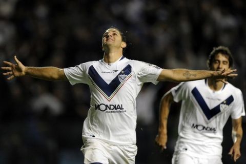 Argentina's Velez Sarsfield forward Juan Martinez (C) celebrates after scoring the team's third goal against Paraguay's Libertad during their Copa Libertadores 2011 quarterfinals first leg football match at "La Bombonera" stadium in Buenos Aires, Argentina, on May 12, 2011. AFP PHOTO / Juan Mabromata (Photo credit should read JUAN MABROMATA/AFP/Getty Images)