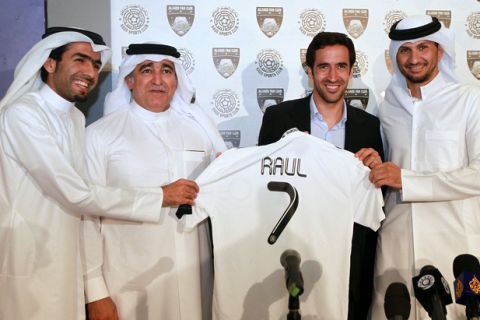 Spanish striker Raul holds his new jersey with Qatari Sheikh Nawaf bin Nasser al-Thani (2nd-L) and Al-Sadd players Talal al-Bloshi (L) and Wissam Rizq (R) after he was unveiled as a new player for the Qatari club in Doha on May 13, 2012. The 34-year-old former Real Madrid star left German side Schalke 04 after two seasons in Gelsenkirchen. AFP PHOTO/KARIM JAAFARKARIM JAAFAR/AFP/GettyImages