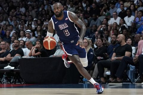 Team USA's LeBron James drives against Australia during the USA Basketball Showcase in Abu Dhabi, United Arab Emirates, Monday, July 15, 2024. (AP Photo/Altaf Qadri)