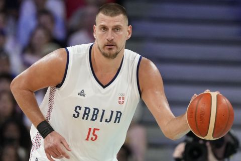 Nikola Jokic, of Serbia, dribbles in a men's basketball game against the United States at the 2024 Summer Olympics, Sunday, July 28, 2024, in Villeneuve-d'Ascq, France. (AP Photo/Michael Conroy)