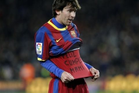 FC Barcelona's Lionel Messi from Argentina celebrates his goal as he shows a sentence on his undershirt reading "happy birthday mummy"  during the Spanish La Liga soccer match against Racing Santander at the Camp Nou stadium in Barcelona, Spain, Saturday, Jan. 22, 2011. (AP Photo/Emilio Morenatti)