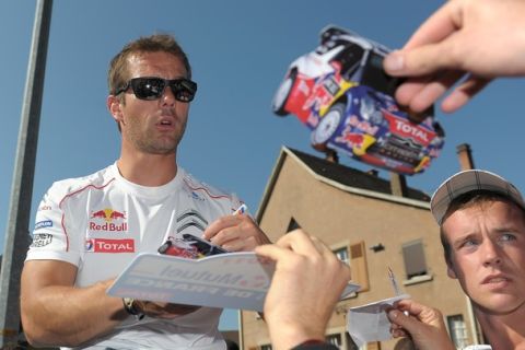 France's rally driver Sebastien Loeb signs autograph in Haguenau, eastern France, on October 02, 2011, during the third and last stage of France?s Rallye Alsace. AFP PHOTO / FREDERICK FLORIN (Photo credit should read FREDERICK FLORIN/AFP/Getty Images)