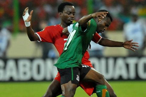 Zambia's Midfielder Christopher Katongo (R) fights off Equatorial Guinea Defender Jose Bogung during the Group A 2012 Africa Cup of Nations football match between Equatorial Guinea and Zambia, in Malabo, on January 29, 2012, at the Malabo stadium. The African Cup of Nations is taking place from January 21 to Febuary 12, 2012. AFP PHOTO / ALEXANDER JOE (Photo credit should read ALEXANDER JOE/AFP/Getty Images)