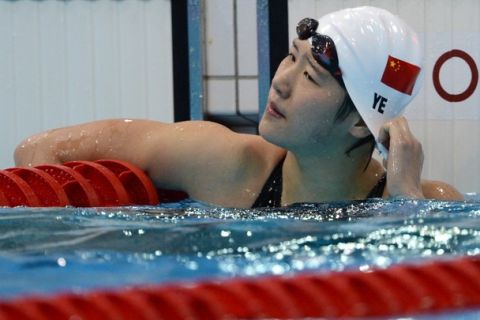 China's Ye Shiwen pulls her cap after finishing the women's 200m individual medley heats swimming event at the London 2012 Olympic Games at the Olympic Park in London on July 30, 2012.  AFP PHOTO / CHRISTOPHE SIMON        (Photo credit should read CHRISTOPHE SIMON/AFP/GettyImages)