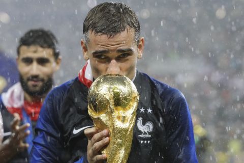 FILE - France's Antoine Griezmann kisses the trophy after the final match between France and Croatia at the 2018 soccer World Cup in the Luzhniki Stadium in Moscow, Russia, Sunday, July 15, 2018. (AP Photo/Matthias Schrader, File)