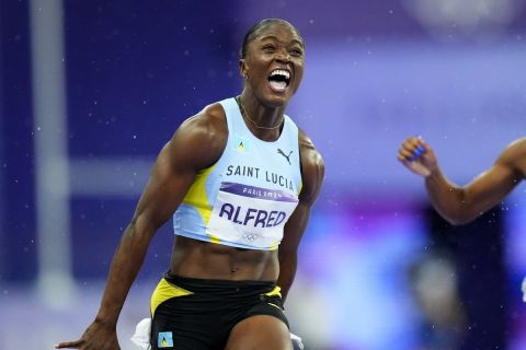 Julien Alfred, of Saint Lucia, celebrates after winning the women's 100-meter final at the 2024 Summer Olympics, Saturday, Aug. 3, 2024, in Saint-Denis, France. (AP Photo/Petr David Josek)