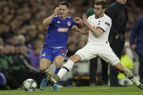 Tottenham's Harry Winks, right, vies for the ball with Olympiakos' Daniel Podence during the Champions League Group B soccer match between Tottenham Hotspur and Olympiakos at the Tottenham Hotspur Stadium in London, Tuesday, Nov. 26, 2019. (AP Photo/Matt Dunham)