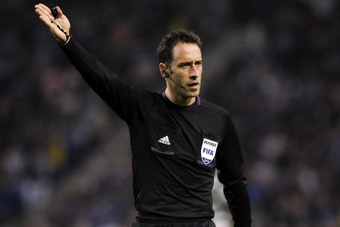 In this picture taken Sunday, Oct. 28, 2013 Portuguese referee Artur Soares Dias gestures at the Portuguese League soccer match between FC Porto and Sporting, at the Dragao stadium in Porto, Portugal. Porto won 3-1.(AP Photo/Paulo Duarte)