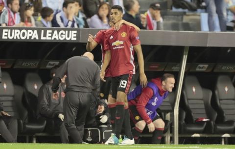 Manchester United's Marcus Rashford is congratulated by Manchester United's Jesse Lingard after scoring the opening goal during a Europa League, semifinal, first leg soccer match between Celta and Manchester United at the Balaidos stadium in Vigo, Spain, Thursday May 4, 2017. (AP Photo/Lalo R. Villar)