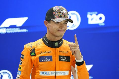 McLaren driver Lando Norris of Britain, centre, celebrates his pole position after qualifying session of the Singapore Formula One Grand Prix at the Marina Bay Street Circuit, in Singapore, Saturday, Sept. 21, 2024. (AP Photo/Vincent Thian)