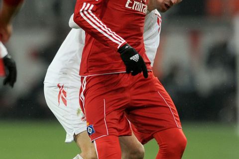 Hamburg's Peruvian striker Jose Paolo Guerrero (front) and Cologne's defender Christian Eichner vie for the ball during the German first division Bundesliga football match 1.FC Cologne vs Hamburger SV in the German city of Cologne on February 12, 2012.  AFP PHOTO / PATRIK STOLLARZ

RESTRICTIONS / EMBARGO - DFL LIMITS THE USE OF IMAGES ON THE INTERNET TO 15 PICTURES (NO VIDEO-LIKE SEQUENCES) DURING THE MATCH AND PROHIBITS MOBILE (MMS) USE DURING AND FOR FURTHER TWO HOURS AFTER THE MATCH. FOR MORE INFORMATION CONTACT DFL. (Photo credit should read PATRIK STOLLARZ/AFP/Getty Images)