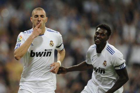 Real Madrid's French forward Karim Benzema (L) celebrates next to teammate Togolese forward Emmanuel Adebayor after scoring their third goal during the Spanish League football match Real Madrid against Getafe at the Santiago Bernabeu stadium in Madrid, on May 10, 2011. AFP PHOTO/JAVIER SORIANO (Photo credit should read JAVIER SORIANO/AFP/Getty Images)