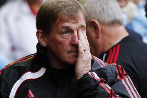 Liverpool's manager Kenny Dalglish wipes his face as he takes his seat before their English Premier League soccer match against Tottenham Hotspur at Anfield in Liverpool, northern England, May 15, 2011.  REUTERS/Phil Noble  (BRITAIN - Tags: SPORT SOCCER) NO ONLINE/INTERNET USAGE WITHOUT A LICENCE FROM THE FOOTBALL DATA CO LTD. FOR LICENCE ENQUIRIES PLEASE TELEPHONE ++44 (0) 207 864 9000