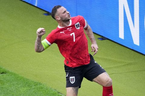 Austria's Marko Arnautovic celebrates after scoring his side's third goal from the penalty spot during a Group D match between Poland and Austria at the Euro 2024 soccer tournament in Berlin, Germany, Friday, June 21, 2024. (AP Photo/Petr Josek)
