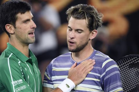 Serbia's Novak Djokovic, left, is congratulated by Austria's Dominic Thiem after winning the men's singles final at the Australian Open tennis championship in Melbourne, Australia, Sunday, Feb. 2, 2020. (AP Photo/Andy Brownbill)