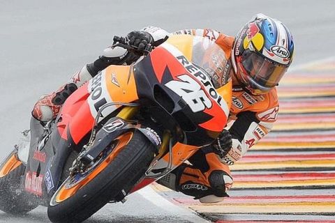 Honda rider Dani Pedrosa from Spain steers his bike during the MotoGP qualifying practice at the  motorcycling Grand Prix of Germany at the Sachsenring circuit in the village of Hohenstein-Ernstthal, near the city of Chemnitz, Germany, Saturday, July 7, 2012. (AP Photo/Jens Meyer) 